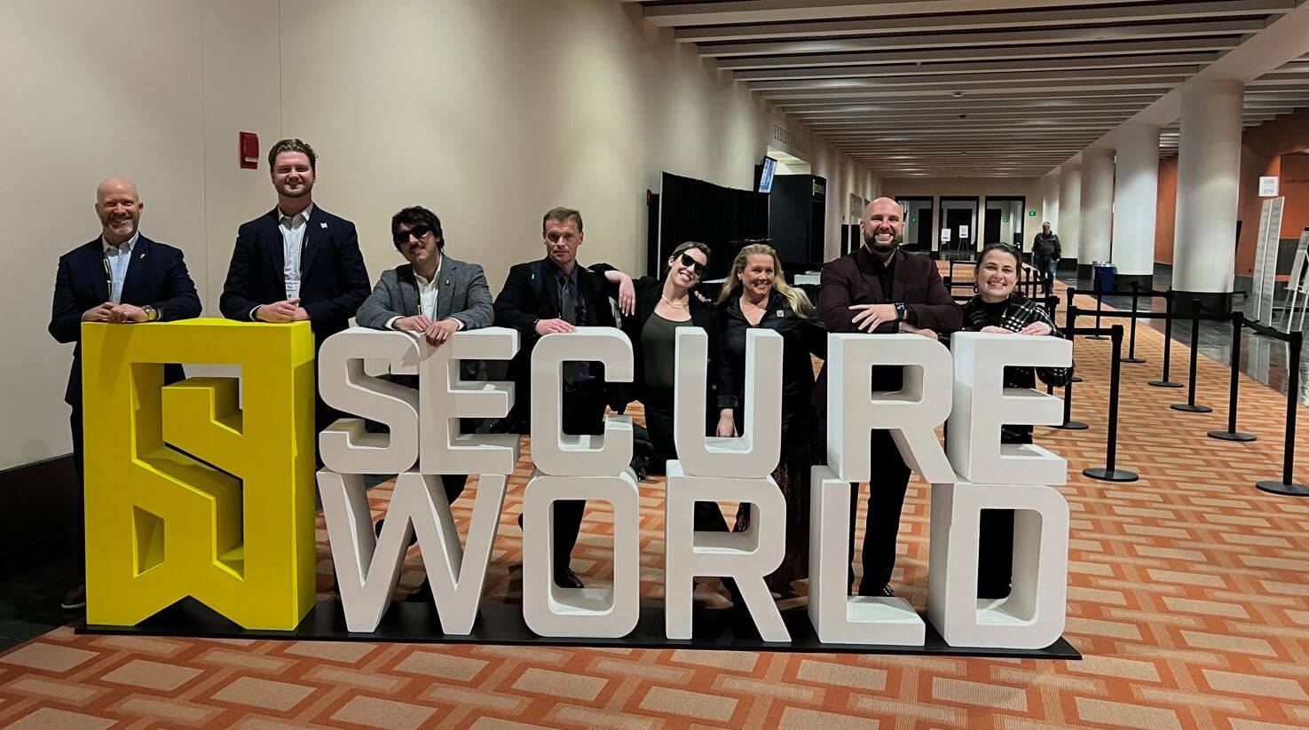 SecureWorld team and block letters sign - small
